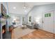 Bright and airy living room offers hardwood floors, a fireplace, and comfortable seating with vaulted ceilings at 2421 Morton St, Charlotte, NC 28208