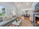 Open-concept living room boasts natural light, wood floors, and views of the kitchen with bar seating at 2421 Morton St, Charlotte, NC 28208