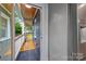 View from inside the home to the wood-covered patio entryway with painted brick walls and tiled patio entrance at 2421 Morton St, Charlotte, NC 28208