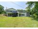 Large backyard with green lawn featuring a deck with stairs leading to upper level at 2617 Shady Lane Ave, Concord, NC 28027