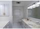 White bathroom with a tiled shower, updated sink and vanity, plus ample lighting at 2617 Shady Lane Ave, Concord, NC 28027