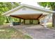 Spacious carport with room for two cars and built in storage, adjacent to yard and trees at 2617 Shady Lane Ave, Concord, NC 28027