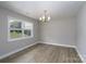 Bright dining room with new floors and natural light from the large window creates an inviting space at 2617 Shady Lane Ave, Concord, NC 28027