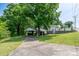 Long driveway with a covered carport and adjacent house and yard on an incline at 2617 Shady Lane Ave, Concord, NC 28027