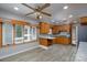 Charming eat-in kitchen with wood cabinets, updated countertops and backsplash, plus a ceiling fan and bright window at 2617 Shady Lane Ave, Concord, NC 28027