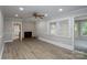 Cozy living room with a brick fireplace, neutral paint, and large window, creating a warm and inviting space at 2617 Shady Lane Ave, Concord, NC 28027