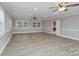 Inviting living room with updated flooring, recessed lighting, and ceiling fan, complemented by natural light from two windows at 2617 Shady Lane Ave, Concord, NC 28027