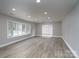 Bright, open living room featuring recessed lighting and luxury vinyl flooring, bathed in natural light from the window at 2617 Shady Lane Ave, Concord, NC 28027