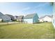Fenced backyard featuring a well-maintained lawn and blue storage garage, providing privacy and storage at 282 Auburn View Rd, Rock Hill, SC 29730