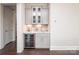 Stylish bar area with sleek gray cabinets, tiled backsplash, and a modern wine refrigerator at 282 Auburn View Rd, Rock Hill, SC 29730