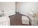Neutral Bedroom featuring a crib, changing table, and cozy chair with an ottoman at 282 Auburn View Rd, Rock Hill, SC 29730