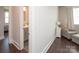 Hallway leading to a bedroom and attached bathroom with neutral walls and dark hardwood floors at 282 Auburn View Rd, Rock Hill, SC 29730