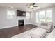 Bright living room featuring dark wood floors, fireplace, a ceiling fan, and lots of natural light at 282 Auburn View Rd, Rock Hill, SC 29730
