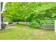 Large backyard with a stone patio, outdoor seating, and a white picket fence at 288 Sand Paver Way # 50, Fort Mill, SC 29708