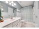 Clean bathroom featuring wainscoting, a vanity with mirror, and a tub/shower combo with curtain at 288 Sand Paver Way # 50, Fort Mill, SC 29708