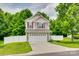 Two-story home with a two-car garage, well-manicured lawn, and white picket fence at 288 Sand Paver Way # 50, Fort Mill, SC 29708