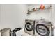 Well-lit laundry room features modern appliances and ample shelving for storage at 288 Sand Paver Way # 50, Fort Mill, SC 29708