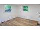 Cozy bedroom with wood flooring, light walls, and natural light from two windows at 301 Carolina Blvd, Salisbury, NC 28146