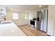 Modern kitchen with stainless steel appliances, white cabinets, and wood-look flooring at 301 Carolina Blvd, Salisbury, NC 28146