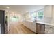 Bright kitchen featuring white cabinets, modern appliances, and wood flooring, offering a clean and stylish design at 301 Carolina Blvd, Salisbury, NC 28146
