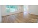 Bright living room with wood flooring and large windows, providing ample natural light and a welcoming atmosphere at 301 Carolina Blvd, Salisbury, NC 28146