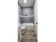 Well-lit bathroom with a bathtub and a shower featuring sleek gray tiling and modern fixtures at 306 E Ratchford Ave, Gastonia, NC 28054
