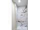 Elegant walk-in shower adorned with luxurious marble-patterned tile, creating a spa-like experience at 306 E Ratchford Ave, Gastonia, NC 28054