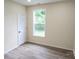 Cozy bedroom showcasing wood-look flooring, a large window and neutral walls at 306 E Ratchford Ave, Gastonia, NC 28054