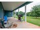 Spacious back porch with grill and seating provides ample room for entertaining, with a large manicured lawn at 3103 Richview Dr, Crouse, NC 28033