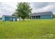 Wide shot of house and detached outbuilding with large manicured lawn at 3103 Richview Dr, Crouse, NC 28033