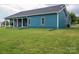 Spacious backyard with lush green grass and a charming home exterior with dark roof at 3103 Richview Dr, Crouse, NC 28033