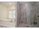 Bathroom with a separate glass-enclosed shower and soaking tub with tile surround at 3103 Richview Dr, Crouse, NC 28033