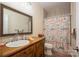 Bathroom featuring vintage wooden vanity, large mirror, and shower with nautical-themed curtain at 3103 Richview Dr, Crouse, NC 28033