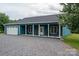 Exterior view of a teal home with a covered porch, attached garage, and gravel driveway at 3103 Richview Dr, Crouse, NC 28033