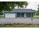 Exterior view of a teal home with covered porch, attached garage, and gravel driveway at 3103 Richview Dr, Crouse, NC 28033
