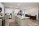 Spacious kitchen featuring stainless steel appliances, an island, and a dining table at 3103 Richview Dr, Crouse, NC 28033