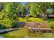 Beautiful backyard with a dock, wooden stairs to the house and a fenced yard at 315 Wood Duck Loop, Mooresville, NC 28117