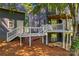 Rear view of a house with multi-level deck, patio and well-maintained landscaping at 315 Wood Duck Loop, Mooresville, NC 28117