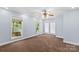Spacious bedroom with carpeted floors, double doors, and large windows offering backyard views and plenty of natural light at 315 Wood Duck Loop, Mooresville, NC 28117