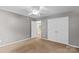 Neutral bedroom featuring carpeted floor, ceiling fan and double door closet at 315 Wood Duck Loop, Mooresville, NC 28117