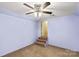 A simple bedroom with carpeted floor and access to a stairway at 315 Wood Duck Loop, Mooresville, NC 28117