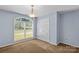 Bright bedroom featuring a large window, double door closet, and neutral carpet at 315 Wood Duck Loop, Mooresville, NC 28117