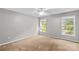 Clean bedroom with neutral carpet, a ceiling fan, and windows providing lots of natural light at 315 Wood Duck Loop, Mooresville, NC 28117