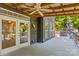 Side view of covered deck with ceiling fan, hot tub and access to the home's interior at 315 Wood Duck Loop, Mooresville, NC 28117
