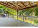 Stunning covered deck featuring a ceiling fan, hot tub, and scenic lake views at 315 Wood Duck Loop, Mooresville, NC 28117