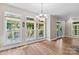 Bright dining area with hardwood floors, decorative lighting, and views of the outdoor living space at 315 Wood Duck Loop, Mooresville, NC 28117