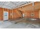 Unfinished garage interior with stairs to an upstairs loft, and utility doors at 315 Wood Duck Loop, Mooresville, NC 28117
