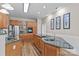 Spacious kitchen features wood cabinets, stainless steel appliances, granite counters, backsplash and recessed lighting at 315 Wood Duck Loop, Mooresville, NC 28117
