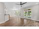 Open living room featuring hardwood floors, recessed lighting, modern ceiling fan, and sliding glass doors at 315 Wood Duck Loop, Mooresville, NC 28117