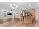 Spacious open concept living area next to kitchen with hardwood floors and modern lighting at 315 Wood Duck Loop, Mooresville, NC 28117